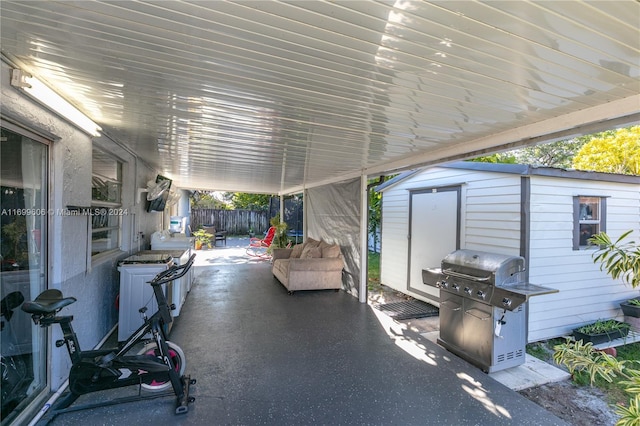 view of patio / terrace with area for grilling and a storage shed