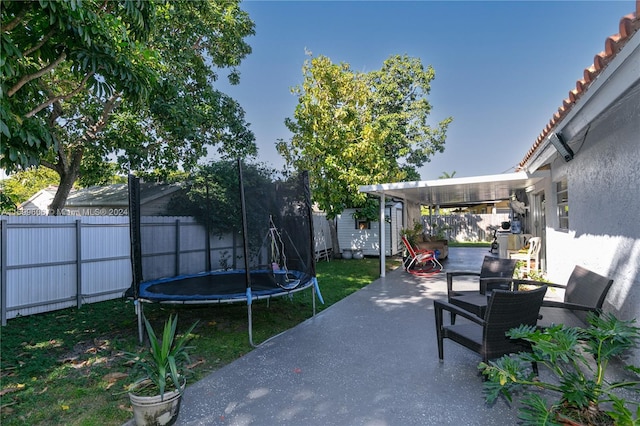 view of patio featuring a shed and a trampoline