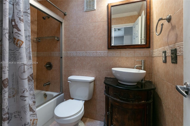 full bathroom with vanity, toilet, tile walls, and shower / bath combo with shower curtain