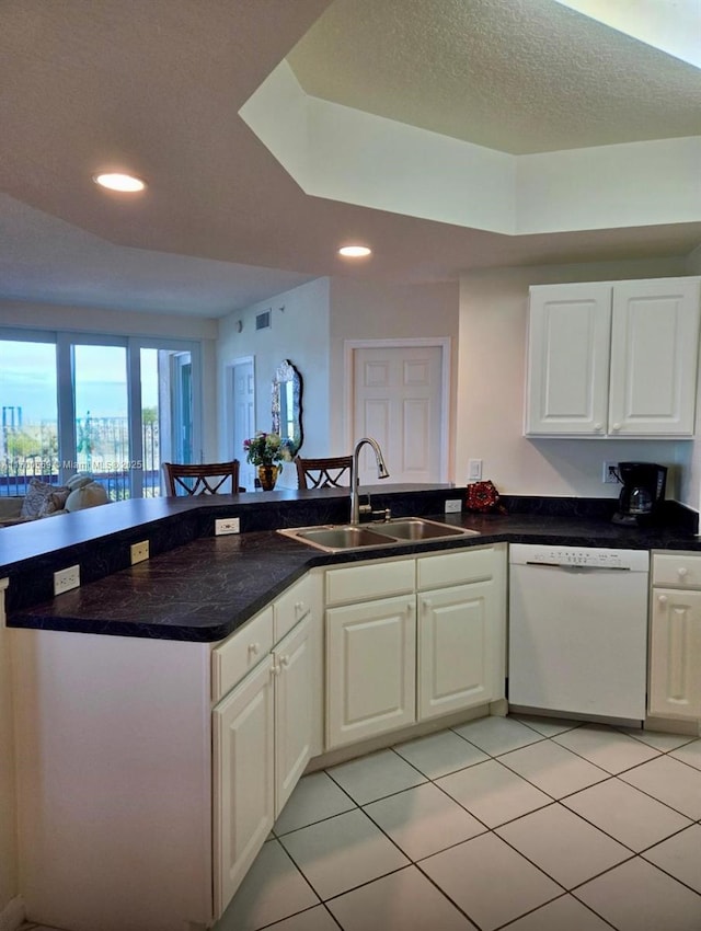 kitchen with dishwasher, recessed lighting, a peninsula, white cabinetry, and a sink