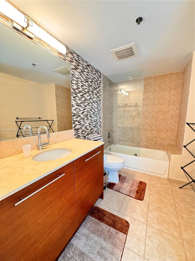 full bathroom with tile patterned floors, vanity, toilet, and tiled shower / bath