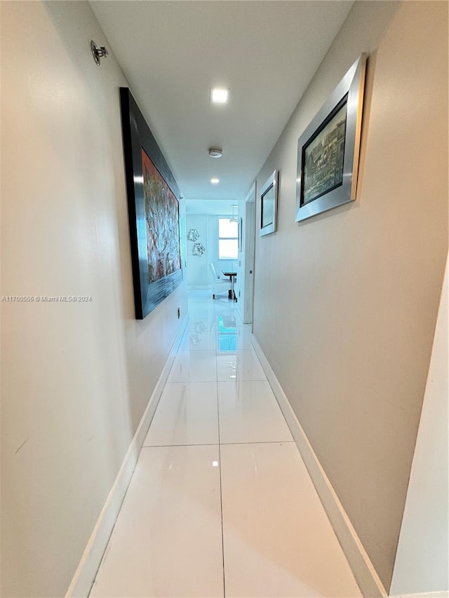 hall with light tile patterned floors