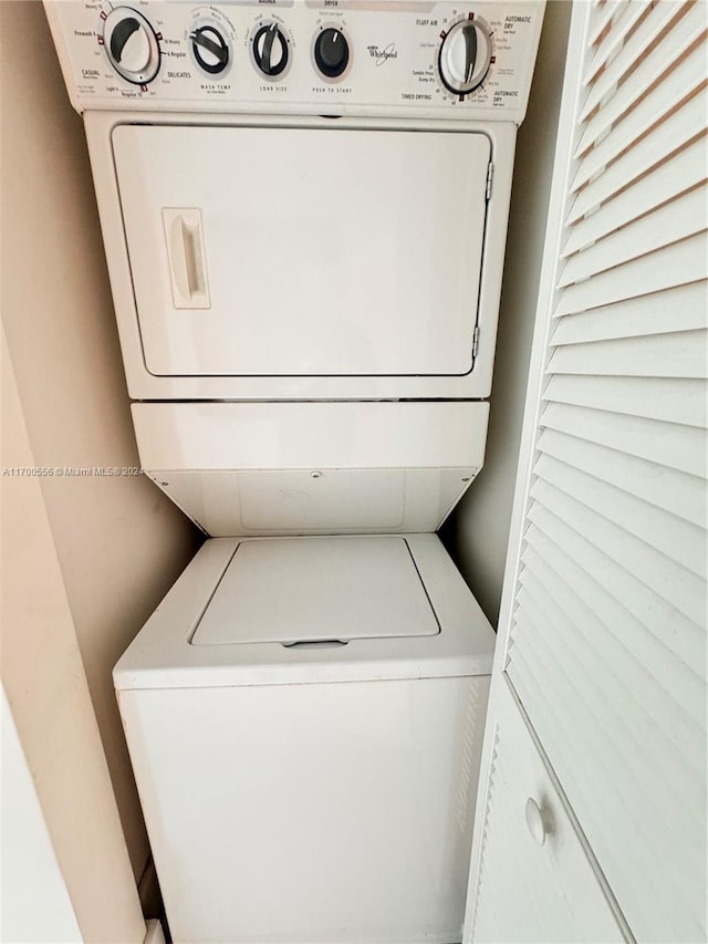 laundry area with stacked washer and clothes dryer