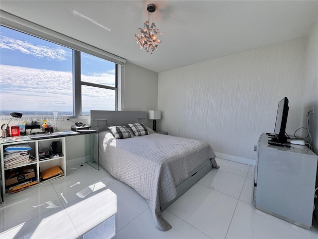 tiled bedroom with a chandelier