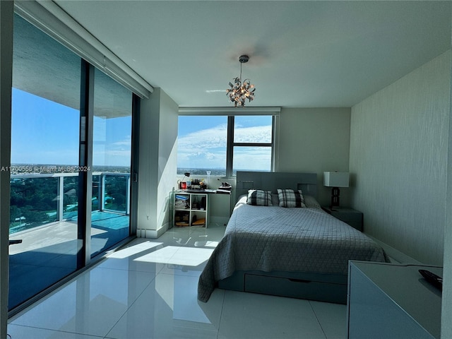 bedroom featuring access to exterior, light tile patterned floors, and expansive windows