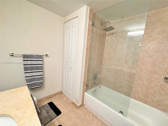 bathroom featuring tile patterned flooring, tiled shower / bath combo, and vanity