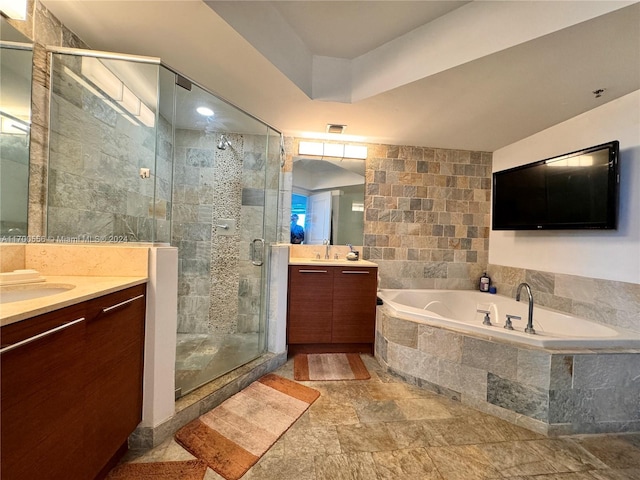 bathroom featuring vanity, separate shower and tub, and tile walls