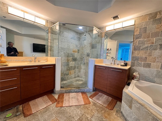 bathroom featuring vanity and shower with separate bathtub