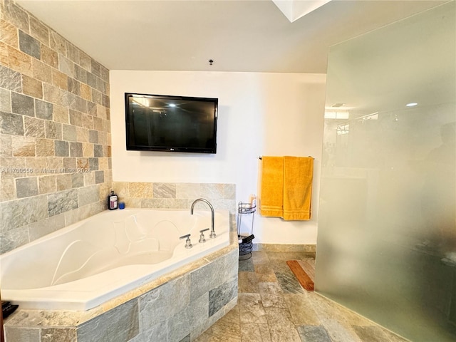 bathroom featuring tiled bath