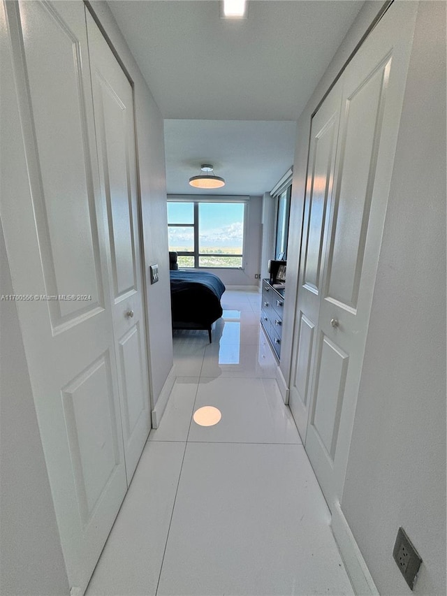 hall with light tile patterned flooring