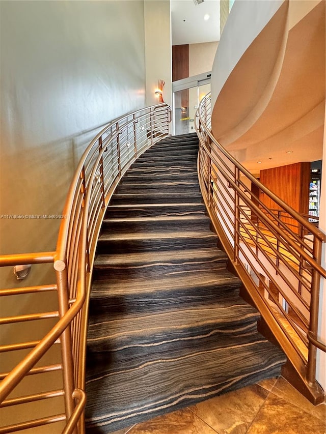 stairs featuring tile patterned flooring