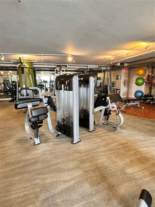 gym featuring a textured ceiling