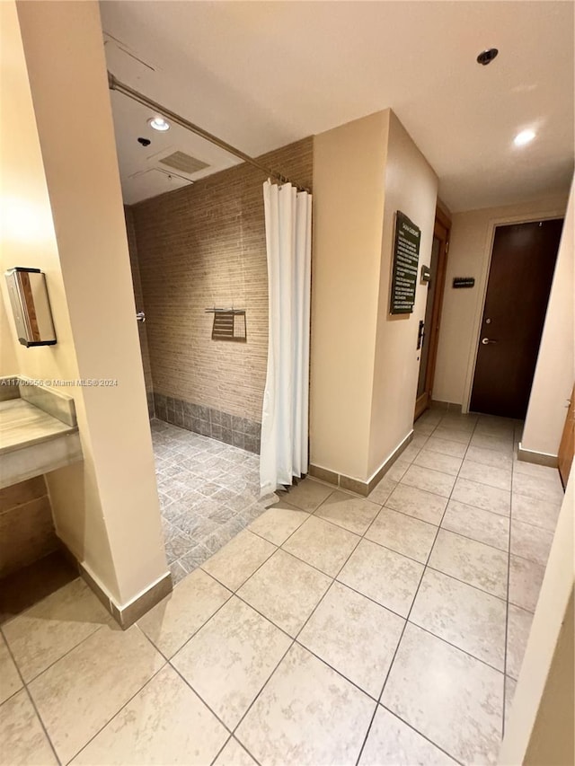 hallway featuring light tile patterned floors