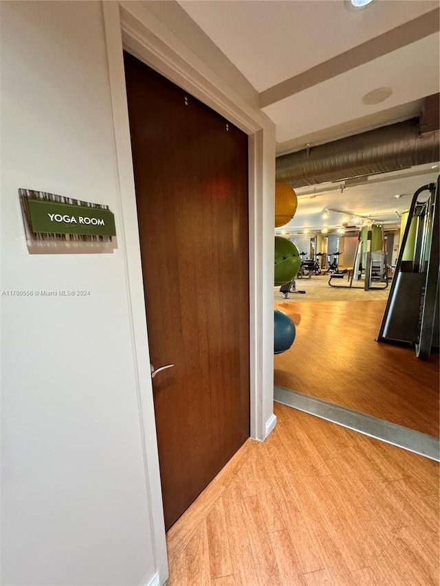 corridor with light hardwood / wood-style flooring