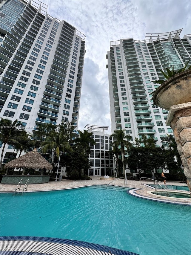 view of pool featuring a community hot tub and a gazebo