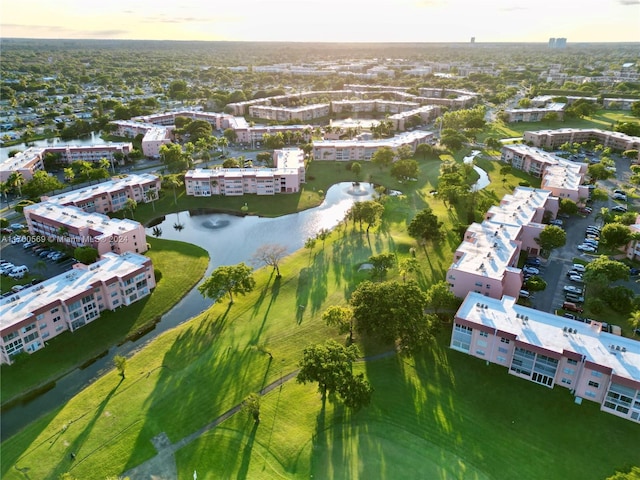 aerial view at dusk featuring a water view