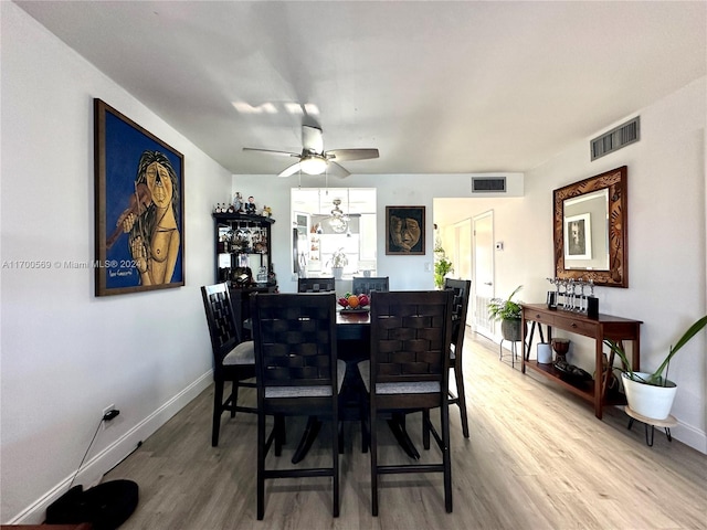 dining area featuring ceiling fan and wood-type flooring