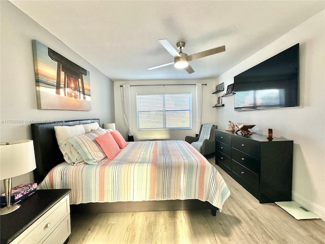 bedroom with light hardwood / wood-style flooring and ceiling fan