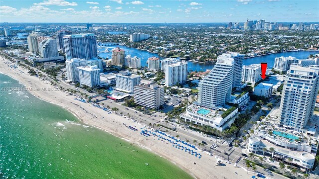 drone / aerial view with a water view and a view of the beach