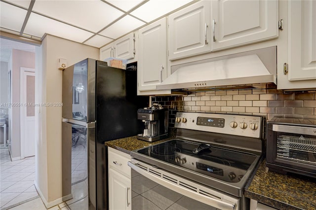 kitchen featuring white cabinets, light tile patterned floors, electric range, and tasteful backsplash