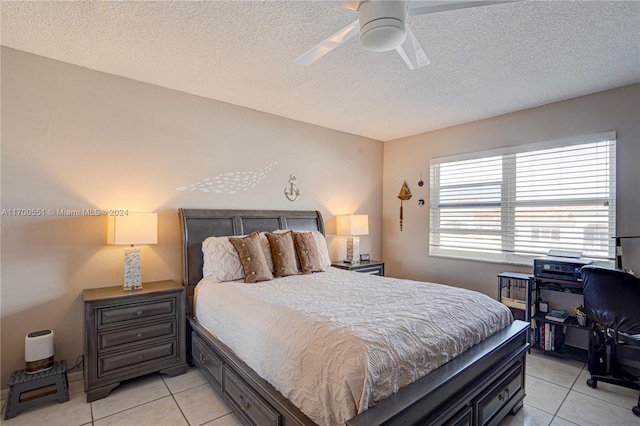 tiled bedroom featuring ceiling fan and a textured ceiling