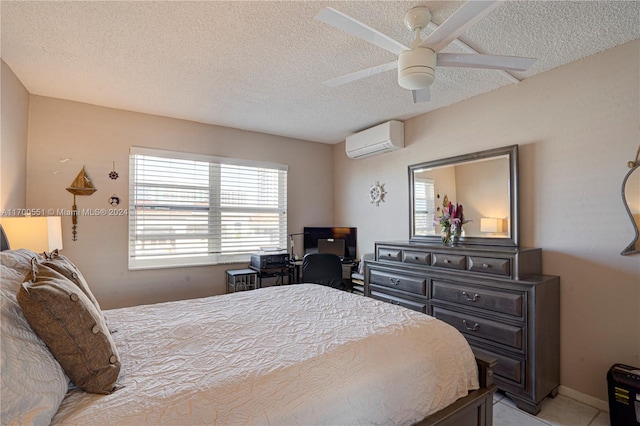 bedroom with a wall mounted AC, ceiling fan, and a textured ceiling