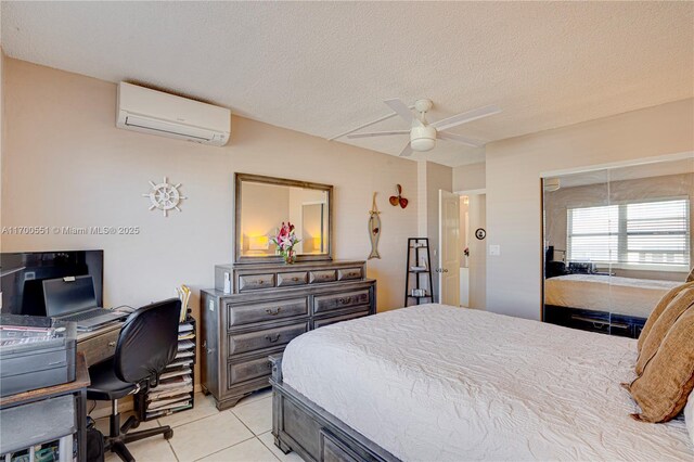 bedroom with a textured ceiling, ceiling fan, and light tile patterned flooring