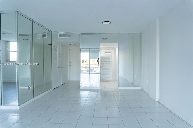 16850 S Glades Dr Unit 3C, North Miami Beach, FL 33162 - spare room featuring light tile patterned flooring and healthy amount of natural light