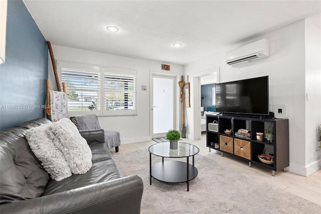 living room with an AC wall unit and light wood-type flooring