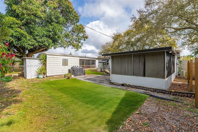 back of property featuring a lawn and a sunroom