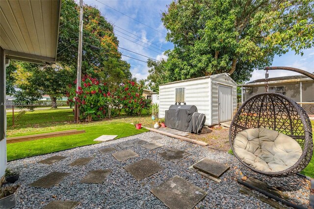 view of patio / terrace featuring area for grilling and a shed