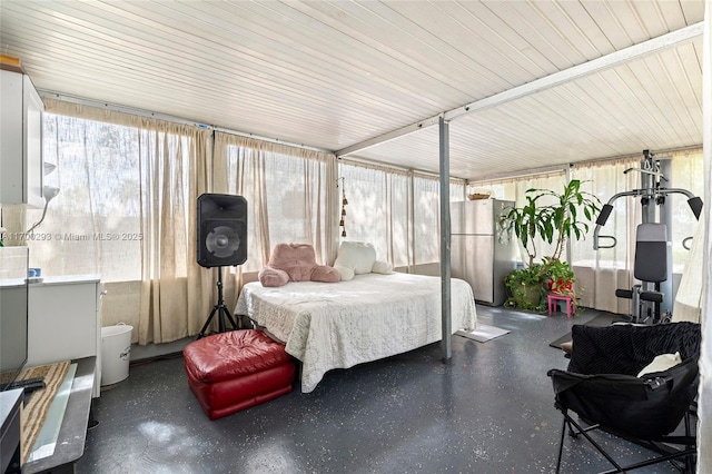 bedroom featuring stainless steel fridge