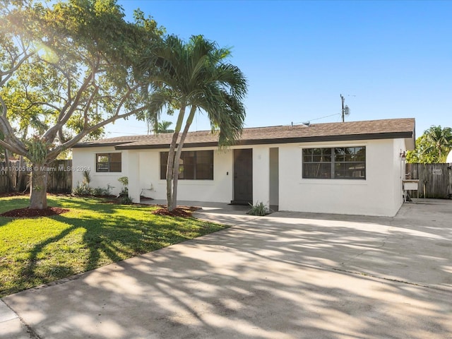 ranch-style home featuring a front yard