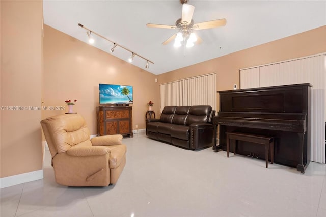 living room featuring tile patterned flooring, ceiling fan, lofted ceiling, and track lighting