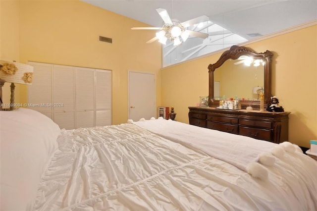 bedroom featuring a closet, high vaulted ceiling, and ceiling fan