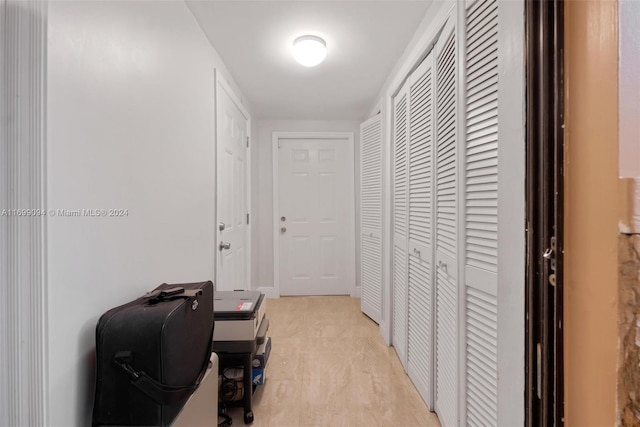 corridor with light wood-type flooring