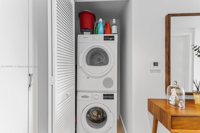 laundry area with stacked washing maching and dryer