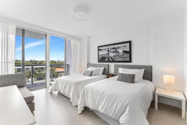 bedroom with access to outside, multiple windows, and expansive windows