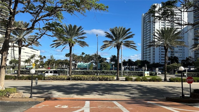 view of road featuring traffic signs, curbs, and sidewalks