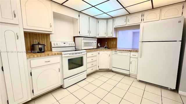 kitchen with white appliances, light countertops, and light tile patterned floors