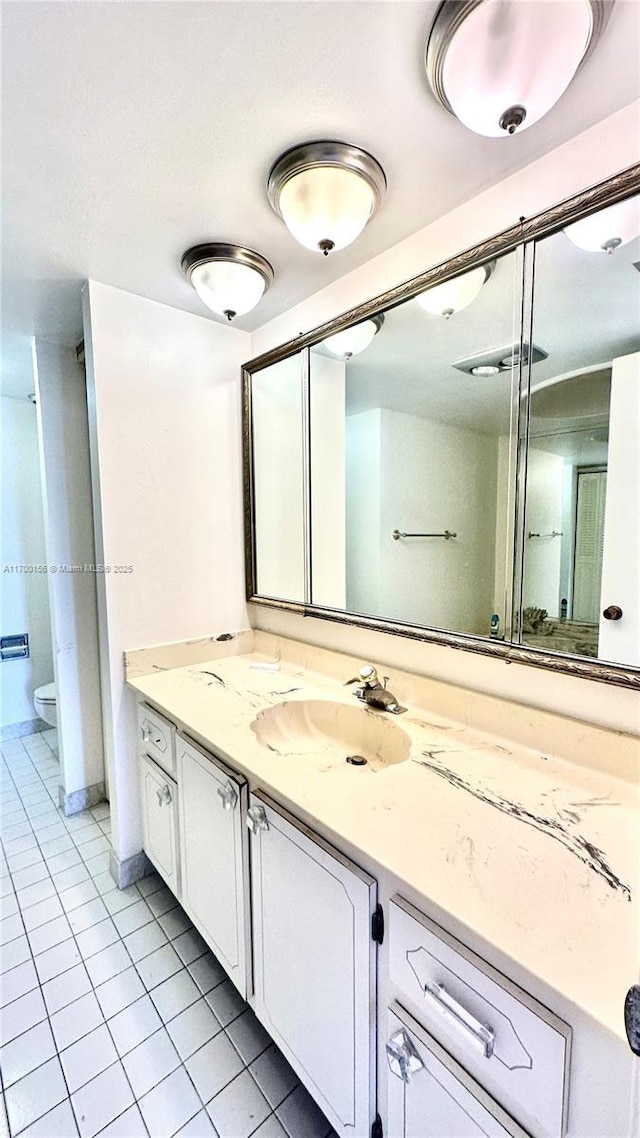 full bathroom featuring tile patterned flooring, vanity, and toilet