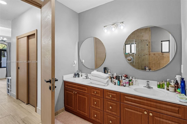 bathroom featuring vanity and tiled shower