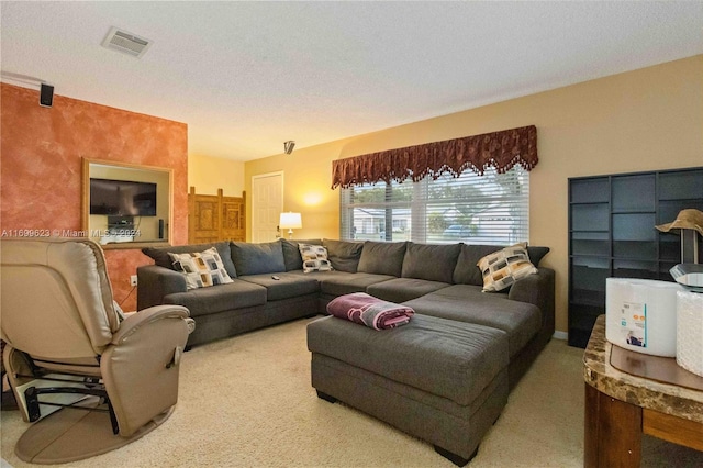 carpeted living room featuring a textured ceiling