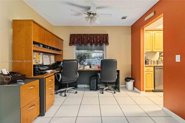 office area featuring light tile patterned floors, built in desk, a textured ceiling, and ceiling fan