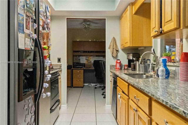 kitchen with light stone countertops, ceiling fan, sink, stainless steel appliances, and light tile patterned floors