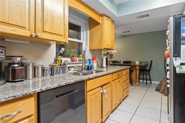 kitchen featuring light stone counters, sink, light tile patterned flooring, and appliances with stainless steel finishes