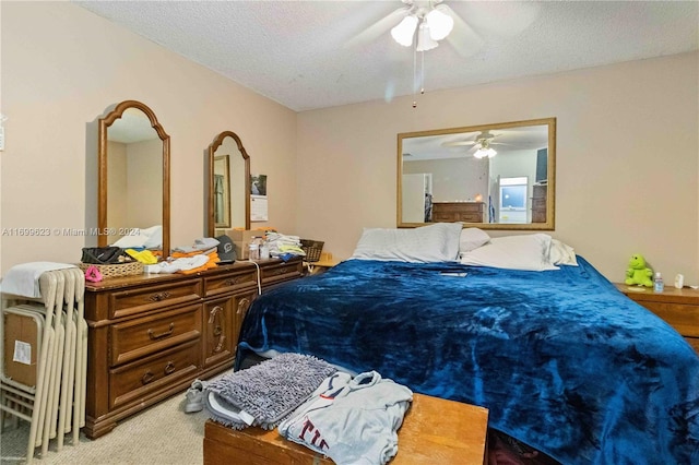 carpeted bedroom with ceiling fan and a textured ceiling