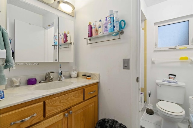 bathroom with tile patterned floors, vanity, and toilet