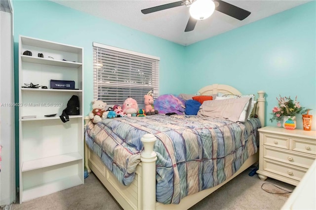 bedroom with ceiling fan and light colored carpet