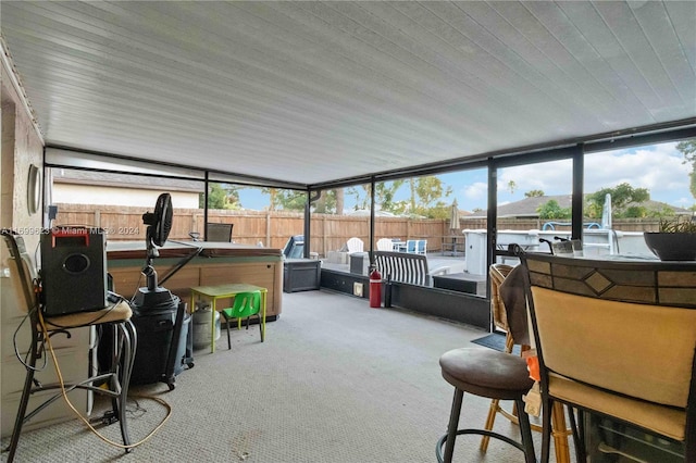 sunroom / solarium featuring vaulted ceiling and a wealth of natural light